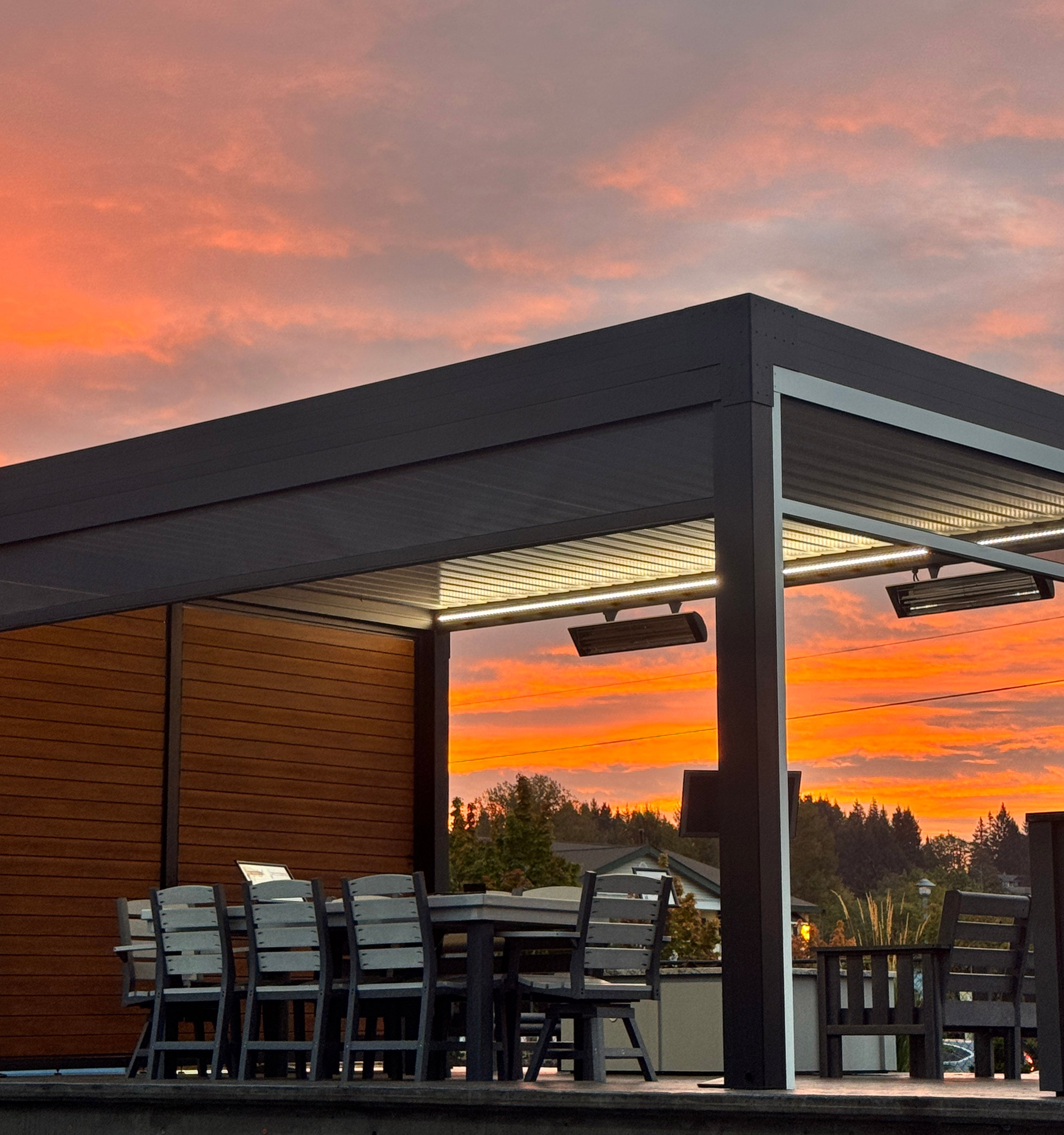 Motorized pergolas and patio screens on a patio at sunset